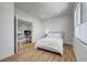 Comfortable bedroom featuring wood-look floors, and bright natural light. Living room in background at 1001 Domnus Ln # 201, Las Vegas, NV 89144