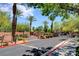 Gated community entrance with palm trees and manicured landscaping creates a welcoming environment at 1001 Domnus Ln # 201, Las Vegas, NV 89144