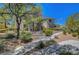 Exterior of the building with inviting sidewalk and beautiful plants and desert landscaping at 1001 Domnus Ln # 201, Las Vegas, NV 89144