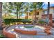 Relaxing hot tub with manicured landscaping and nearby condo buildings, providing a tranquil neighborhood experience at 1001 Domnus Ln # 201, Las Vegas, NV 89144