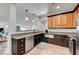 Kitchen featuring stainless appliances, wooden cabinets, and granite countertops at 1001 Domnus Ln # 201, Las Vegas, NV 89144