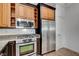 Updated kitchen featuring stainless steel appliances, granite countertops, and custom cabinets at 1001 Domnus Ln # 201, Las Vegas, NV 89144