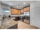 Well-lit kitchen featuring stainless steel appliances, granite countertops, and wooden cabinets at 1001 Domnus Ln # 201, Las Vegas, NV 89144