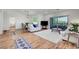 Spacious living room with ample natural light, wood floors, and an open floor plan at 1001 Domnus Ln # 201, Las Vegas, NV 89144