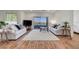 Light and airy living room with wood flooring, white walls, and balcony access at 1001 Domnus Ln # 201, Las Vegas, NV 89144