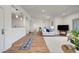 Open concept living room with wood floors, white walls and a light and airy ambiance at 1001 Domnus Ln # 201, Las Vegas, NV 89144