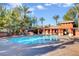 A refreshing community pool surrounded by palm trees and lounge chairs, perfect for relaxation and enjoyment at 1001 Domnus Ln # 201, Las Vegas, NV 89144