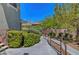 Landscaped community walkway lined with lush greenery and mountain views in the distance at 1001 Domnus Ln # 201, Las Vegas, NV 89144