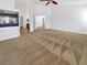 Large bedroom has neutral carpet, fireplace, and ensuite bathroom, all illuminated by natural light at 10056 Cranbrook Falls Ct, Las Vegas, NV 89148