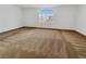 Bright, empty bedroom with carpet and large windows, ready for personalization at 10056 Cranbrook Falls Ct, Las Vegas, NV 89148