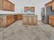 Spacious kitchen features wood cabinets, granite counters, tile floor, and stainless steel refrigerator at 10056 Cranbrook Falls Ct, Las Vegas, NV 89148