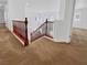Carpeted staircase and upper hallway with wood railing and views to another room at 10056 Cranbrook Falls Ct, Las Vegas, NV 89148