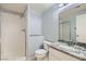 Granite vanity and tiled shower in a well-lit bathroom at 10241 Regents Cross Pl, Las Vegas, NV 89144