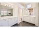 Bright Primary bathroom featuring double sinks, a large mirror, and tile flooring at 10241 Regents Cross Pl, Las Vegas, NV 89144