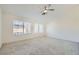 Spacious bedroom with plush carpeting, ceiling fan, and bright windows at 10241 Regents Cross Pl, Las Vegas, NV 89144
