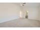 Spacious bedroom featuring high ceilings, a ceiling fan, and access to the bathroom and stairs at 10241 Regents Cross Pl, Las Vegas, NV 89144