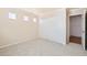 Comfortable bedroom with three small windows and a sliding door closet at 10241 Regents Cross Pl, Las Vegas, NV 89144