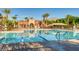 Community pool featuring blue lane lines, lounge furniture, and palm trees at 10241 Regents Cross Pl, Las Vegas, NV 89144