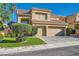 Charming two-story home features a two-car garage, well-manicured lawn, and desert landscaping at 10241 Regents Cross Pl, Las Vegas, NV 89144