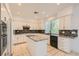 Modern kitchen with white cabinetry, granite countertops, stainless steel appliances, and a central island at 10241 Regents Cross Pl, Las Vegas, NV 89144