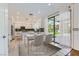 Bright kitchen and dining area featuring modern appliances and a view of the outdoor pool at 10241 Regents Cross Pl, Las Vegas, NV 89144