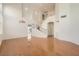 Spacious living room with gleaming hardwood floors and a staircase to the upper level at 10241 Regents Cross Pl, Las Vegas, NV 89144