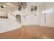 Expansive living room features shiny hardwood floors, a chandelier, and large windows at 10241 Regents Cross Pl, Las Vegas, NV 89144