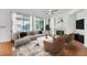 Comfortable living room with a fireplace, large windows, and stylish furniture at 10241 Regents Cross Pl, Las Vegas, NV 89144