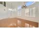 Bright living room with hardwood floors, chandelier, plantation shutters, and abundant natural light at 10241 Regents Cross Pl, Las Vegas, NV 89144