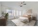 Relaxing main bedroom with a king bed, ceiling fan, and bright natural light at 10241 Regents Cross Pl, Las Vegas, NV 89144