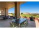 Outdoor patio with seating offering views of the golf course and mountains at 10241 Regents Cross Pl, Las Vegas, NV 89144