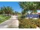 The Trails Park community sign with beautiful foliage and a glimpse of the walking path at 10241 Regents Cross Pl, Las Vegas, NV 89144
