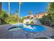 Sparkling pool with an attached spa and surrounded by lush palm trees at 10241 Regents Cross Pl, Las Vegas, NV 89144