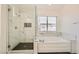 Newly remodeled shower featuring elegant white marble tiling and glass doors at 10241 Regents Cross Pl, Las Vegas, NV 89144