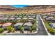 Scenic aerial view of a residential neighborhood, featuring well-maintained homes, green spaces, and tree-lined streets at 10697 Acacia Park Pl, Las Vegas, NV 89135
