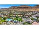 Community aerial view showcasing neighborhood amenities, pool, playground, and mountain views for serene and active living at 10697 Acacia Park Pl, Las Vegas, NV 89135