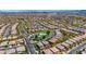 Expansive aerial shot of a Primary-planned community, showcasing the neighborhood layout, community pool, and surrounding landscape at 10697 Acacia Park Pl, Las Vegas, NV 89135