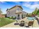 Relaxing backyard featuring a pool, spa, fire pit, lounge chairs, and patio at 10697 Acacia Park Pl, Las Vegas, NV 89135