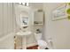 Powder room featuring a pedestal sink, oval mirror, and decorative accents at 10697 Acacia Park Pl, Las Vegas, NV 89135