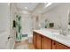 A standard bathroom with a shower-tub combination and wooden vanity at 10697 Acacia Park Pl, Las Vegas, NV 89135