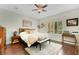 Comfortable bedroom features hardwood floors, natural lighting, and a ceiling fan at 10697 Acacia Park Pl, Las Vegas, NV 89135
