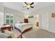 Comfortable bedroom featuring a ceiling fan and natural light at 10697 Acacia Park Pl, Las Vegas, NV 89135