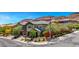 Two-story house featuring desert landscaping, neutral tones, and a mountain in the background at 10697 Acacia Park Pl, Las Vegas, NV 89135