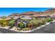 Two-story home with well-maintained landscaping, mature trees, and a welcoming front yard, in a suburban neighborhood at 10697 Acacia Park Pl, Las Vegas, NV 89135