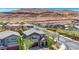 Picturesque suburban homes nestled against a desert mountain backdrop under a clear, sunny sky at 10697 Acacia Park Pl, Las Vegas, NV 89135