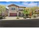 Charming two-story home with a manicured front yard and an inviting covered porch at 10697 Acacia Park Pl, Las Vegas, NV 89135