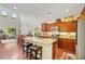 Open kitchen boasts an island with seating, granite counters, and stainless steel appliances at 10697 Acacia Park Pl, Las Vegas, NV 89135