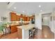 Kitchen with granite counters, stainless appliances and an island with bar stool seating at 10697 Acacia Park Pl, Las Vegas, NV 89135