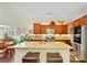 Updated kitchen features an island with seating, granite counters, and stainless steel appliances at 10697 Acacia Park Pl, Las Vegas, NV 89135