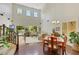 Open-concept living room with high ceilings and natural light with stair access at 10697 Acacia Park Pl, Las Vegas, NV 89135